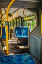 Interior of a city bus. Empty bus interior. Bus with blue seats and yellow handrails Royalty Free Stock Photo