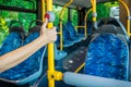 Interior of a city bus. Empty bus interior. Bus with blue seats and yellow handrails Royalty Free Stock Photo