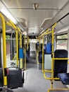 Interior of a city bus. Empty bus interior. Bus with blue seats and yellow handrails. Public transport in the city of Cluj Romania