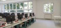 Interior of classroom with computers. Classroom in the new school. White walls, large windows and new classroom furniture.