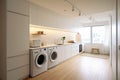 Interior clean white laundry room with front load washer and dryer units. Royalty Free Stock Photo