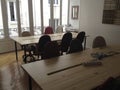 interior co working space rows with concrete white walls,black chair,wood brown and white table and conference room front view