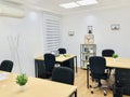 interior co working space rows with concrete white walls,black chair,wood brown and white table and conference room front view