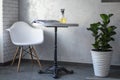 Interior in the coffee house. White table and chair in the corner of the cafe with tea on the table. Royalty Free Stock Photo