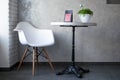 Interior in the coffee house. White table and chair in the corner of the cafe with tea on the table. Royalty Free Stock Photo