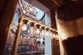 Interior of the coffee shop with overlooks the beautiful old building, showcase decorated with lamps and dishes, inside Royalty Free Stock Photo