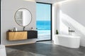 Interior of comfortable bathroom with white walls, concrete floor, cozy black wash basin