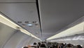 Interior of commercial airplane cabin during flight with passengers Royalty Free Stock Photo