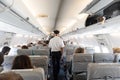 Interior of commercial airplane with passengers on their seats during flight.