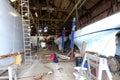 The interior of a boat repair yard, England. Boats under repair and slipways.