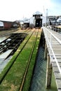 The interior of a boat repair yard, England. Boats under repair and slipways.