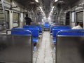 Interior of a commuter train compartment. Local train arriving at a railway station of Mumbai Central.