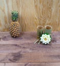 Interior composition of a home on wood table or floor and wall. Handmade white lotus aroma candle. Tropical fresh pineapple. Decor Royalty Free Stock Photo