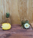 Interior composition of a home on wood table or floor and wall. Handmade white lotus aroma candle. Tropical fruit fresh pineapple Royalty Free Stock Photo