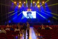 interior of the concert hall at the Altice Arena in Lisbon On the stage screen a young actor acting out an expression of boredom