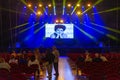 interior of the concert hall at the Altice Arena in Lisbon On the stage screen a young actor acting out an expression of boredom