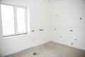 Interior construction of housing project with drywall installed and patched without painting applied, plastered walls and Royalty Free Stock Photo