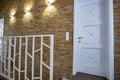 Interior of a contemporary home with spacious hallway, room doors and staircase railing in modern style