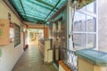 Interior corridor of a building with access to housing doors and an exterior access with a metal and glass structure