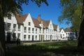 Interior courtyard and gardens of a beguinage in Bruges, Belgium. Royalty Free Stock Photo