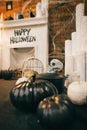 Interior of the cozy apartments is decorated for Halloween with skulls, cobwebs, candles and pumpkins. Background. Vertical. Royalty Free Stock Photo