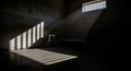 Prison Cell with Sunlight Streaming Through Bars onto a Bed and Table jail incarceration Royalty Free Stock Photo