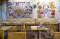 Interior decorating with tables and chairs with pictures on the wall in Japanese restaurant