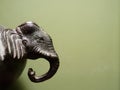 Interior or decoration in antiques, vintage, or retro style of elephant head over dark green background Royalty Free Stock Photo