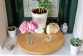 Interior decoration: home corner with a pink rose, a dried pumpkin, a glass vase with wild flowers