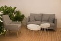 Interior decoration, with soft sofa and white table. Cozy place for rest