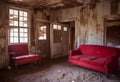 Interior of the deserted desert building with a red sofa and armchair, AI-generated. Royalty Free Stock Photo