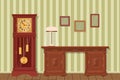 Interior design. Antique desk, grandfather clock, lamp with lampshade and frames on background of striped wallpaper