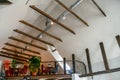 Interior design in a cafe. View of the ceiling in the restaurant. Designer ceilings, decorative wooden beams, metal chandeliers