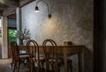 Interior design of cafe. Wooden table with chairs in vintage and loft style with black lamp above table Royalty Free Stock Photo