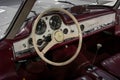 Interior design of a classic and vintage Mercedes Benz in maroon and white