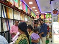 Interior Design Cloth Store and Colorful Men shirt, pant, saree and blouse rolled and well arranged in a shelf Royalty Free Stock Photo