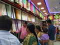 Interior Design Cloth Store and Colorful Men shirt, pant, saree and blouse rolled and well arranged in a shelf