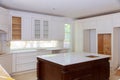 Interior design construction of a kitchen with cabinet maker installing custom Royalty Free Stock Photo