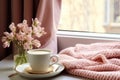 interior design, Cozy Easter, spring still life scene. Cup of coffee, opened notebook, pink knitted plaid on windowsill.