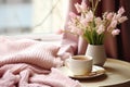 interior design, Cozy Easter, spring still life scene. Cup of coffee, opened notebook, pink knitted plaid on windowsill. Royalty Free Stock Photo
