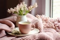 interior design, Cozy Easter, spring still life scene. Cup of coffee, opened notebook, pink knitted plaid on windowsill.