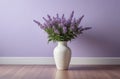 interior design, cozy home. vase of lavender on floor near wall in pastel violet tones Royalty Free Stock Photo