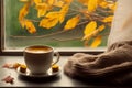 interior design, Cup of autumn tea (coffee, chocolate) and yellow dry leaves near a window, copy space. Royalty Free Stock Photo