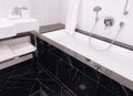 Interior design and decoration materials, luxury black marble tiled bathroom in five stars hotel room Royalty Free Stock Photo