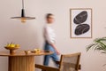 Interior design of domestic dining room space with two mock up poster frames, round table, chair, pedant lamp, decoration and Royalty Free Stock Photo