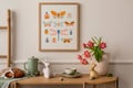 Interior design of easter living room interior with mock up poster frame, glass vase with tulips, wooden sideboard, easter bunny Royalty Free Stock Photo