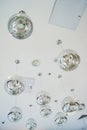 The interior design element of a huge store is the original form of transparent round glass ball-lamps of silver color