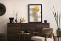 Interior design of harmonized living room with brown commode, design boucle armchair, coffee table, decoration, mock up poster Royalty Free Stock Photo