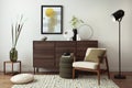 Interior design of harmonized living room with brown commode, design boucle armchair, coffee table, decoration, mock up poster Royalty Free Stock Photo