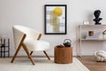 Cozy and stylish living room with mock up poster, white pouf, lamp, consola and personal accessories. Beige wall with carpet. Home